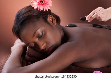 Young woman getting lastone therapy at spa salon