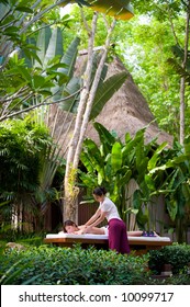 A Young Woman Getting A Massage In A Tropical Spa