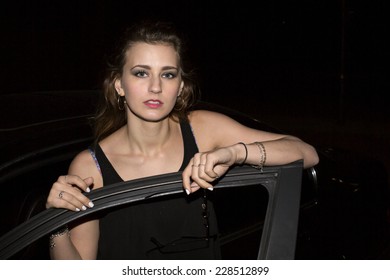 Young Woman Getting Out Of Her Car In The Night