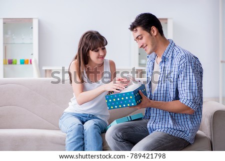 Young woman getting pet rabbit as birthday present