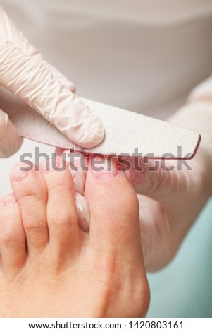 Young woman getting professional pedicure