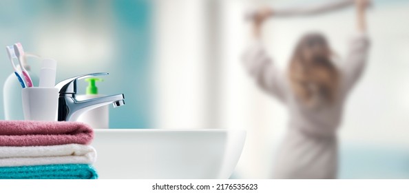 Young Woman Getting Ready In The Bathroom And Sink In The Foreground