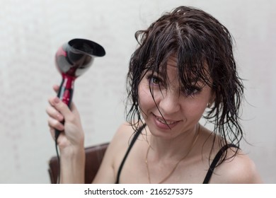 Young Woman Getting Ready For Date Drying Her Head With A Hair Dryer In Front Of A Mirror.