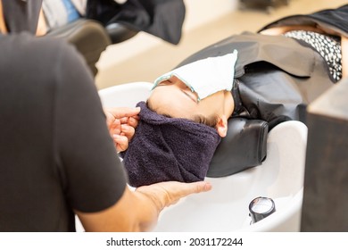 Young Woman Getting Shampoo At The Hair Salon