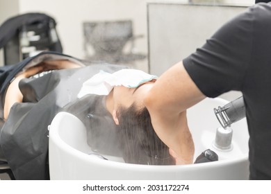 Young Woman Getting Shampoo At The Hair Salon