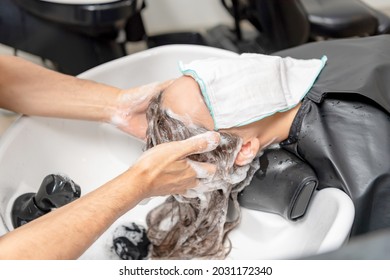 Young Woman Getting Shampoo At The Hair Salon