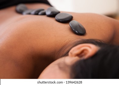Young Woman Getting Spa Treatment With Stone Massage