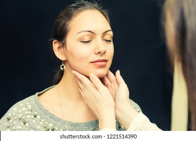 Young Woman Getting Thyroid Exam At Clinic. 