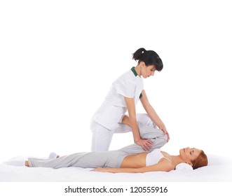 Young woman getting traditional thai stretching massage by therapist isolated on white background