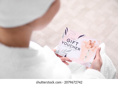 Young Woman With Gift Voucher For Massage At Home