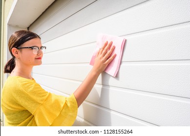 Young Woman Or Girl Cleaning Garage Door Pvc