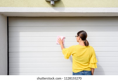 Young Woman Or Girl Cleaning Garage Door Pvc