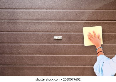 Young Woman Or Girl Hand Cleaning Garage Door Pvc
