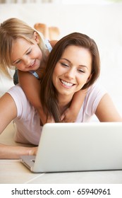 Young Woman With Girl Using Laptop Computer