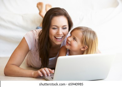 Young Woman With Girl Using Laptop Computer