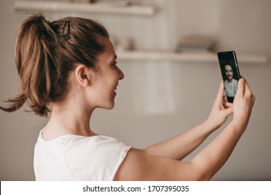 Young Woman, Girl Is Video Chatting With Boyfriend From Smartphone. Distance Communication, Online Dating, Applications, Quarantine, Coronavirus, Virtual Communication, Stay At Home, Covid.