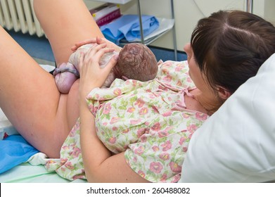 Young Woman Giving Birth In Hospital