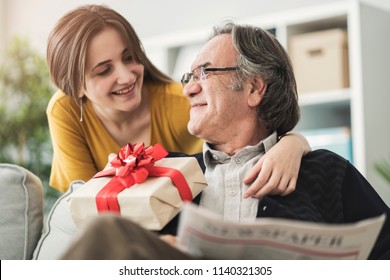 Young Woman Giving Gift Her Father