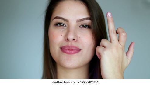 Young Woman Giving Middle Finger, Pretty Girl With Attitude Shows Offensive Gesture While Smiling