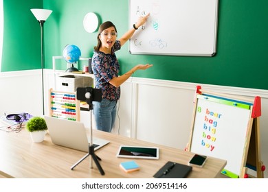 Young Woman Giving Virtual Classes To Preschool Kids And Teaching The Alphabet During A Live Stream Or Video Call  