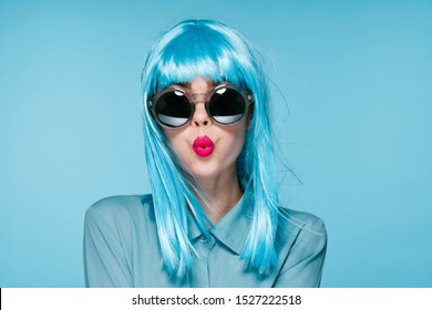 young woman in glasses looks at the camera young in a wig