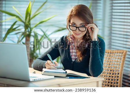 Young woman in glasses studying 