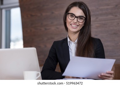 Young Woman In Glasses Working In Office