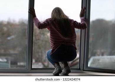 Young woman is going to commit suicide near window