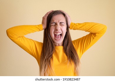 Young Woman Going Crazy On Yellow Background