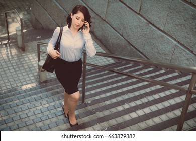 Young Woman Going Up The Stairs Top View.