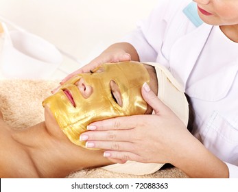 Young Woman With Gold Facial Mask.