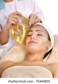 Young Woman With Gold Facial Mask.