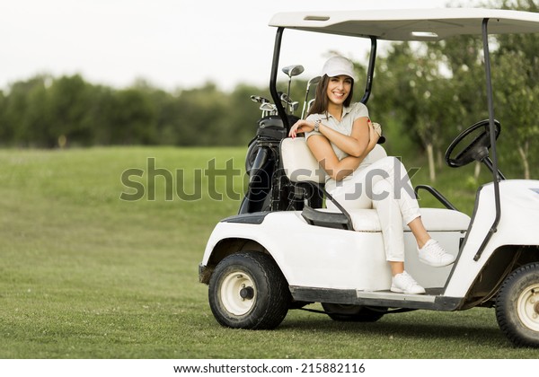 Young woman at golf\
cart