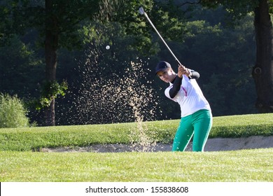 Young Woman Golfer Chipping Golf Ball Out.