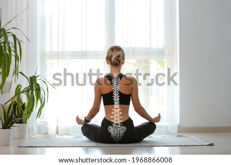 Young woman with good posture meditating at home, back view Сток-фото © 