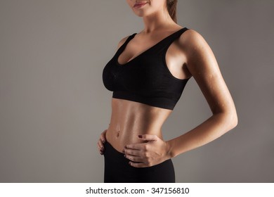 Young woman in good sports shape showing her ideal press - Shutterstock ID 347156810