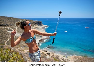 Young Woman With Gopro Camera On Mediterranean Coast In Summer