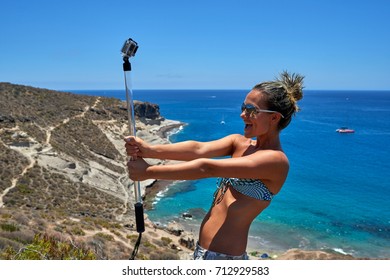 Young Woman With Gopro Camera On Mediterranean Coast In Summer