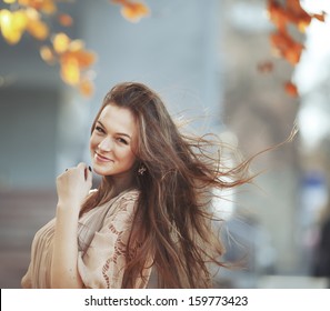 Young woman with gorgeous windy hair. Street Portrait.