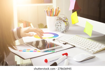 Young Woman Graphic Designer Using Graphic Tablet To Do His Work At Desk