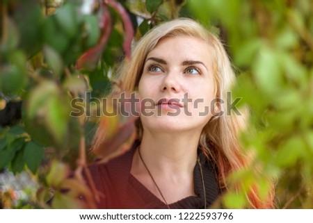 Similar – Young pretty woman in a pink blazer stands in front of an orange wall