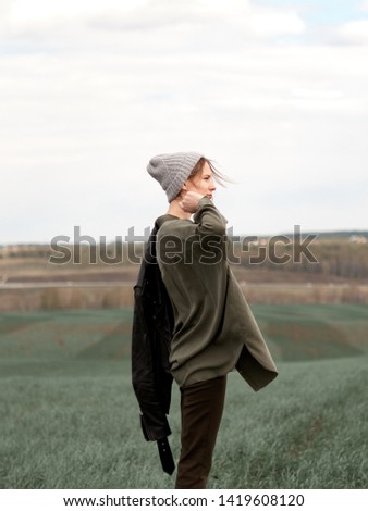 Image, Stock Photo Low angle view of blonde white girl posing in the forest with trees in the background.