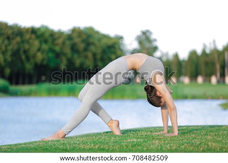 Similar – Active slim young woman doing yoga by the lake