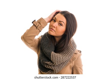A Young woman with a grey scarf is looking ahead