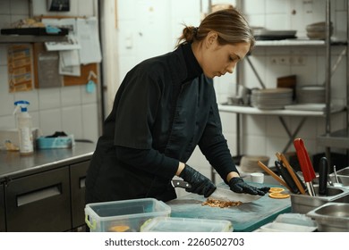 Young woman grinds nuts for a fruit salad - Powered by Shutterstock