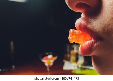 Young Woman With Gummy In Her Mouth.