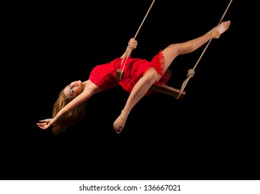 Young woman gymnast on rope on black background