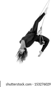 Young woman gymnast on rope on white  background, black and white