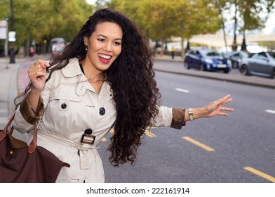 Young Woman Hailing A Cab