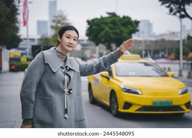 Young Woman Hailing a Taxi on Urban Street - Powered by Shutterstock